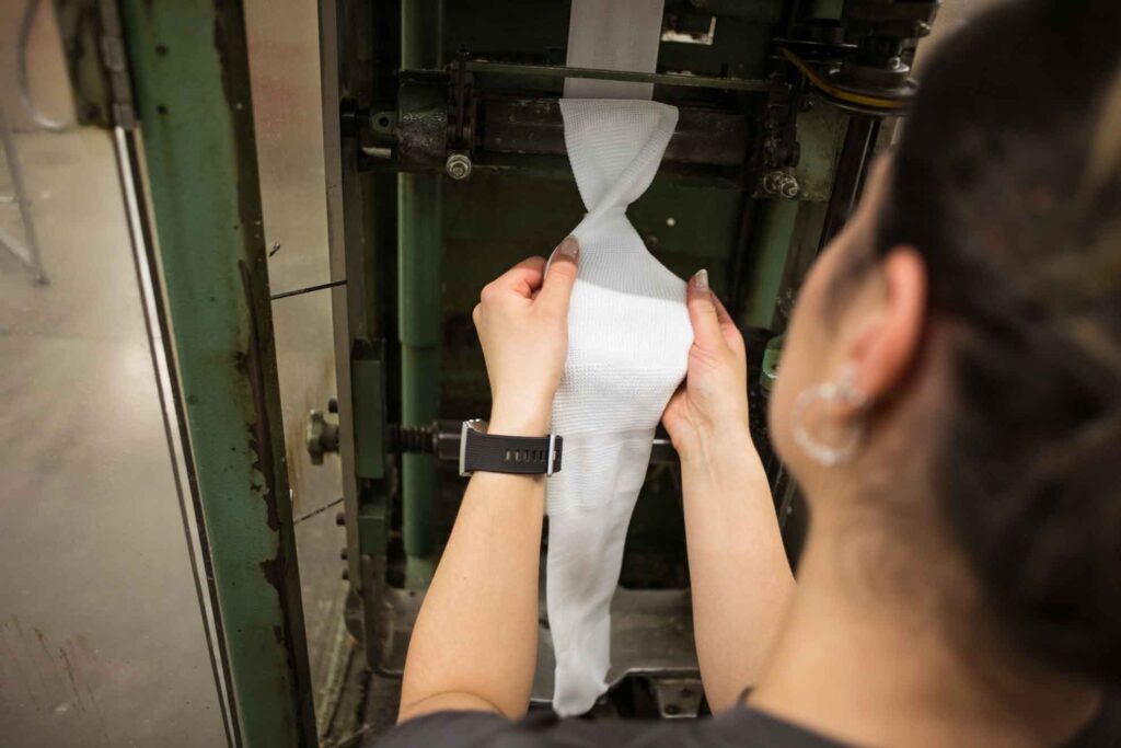 Person inspecting knit fabric
